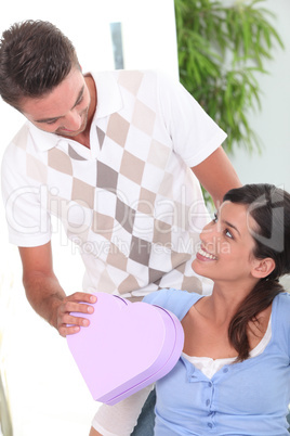 Man giving gift to woman