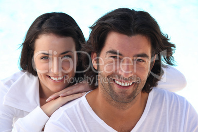 Head and shoulders shot of a well matched couple in white