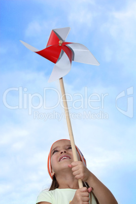 Little girl playing with windmill toy