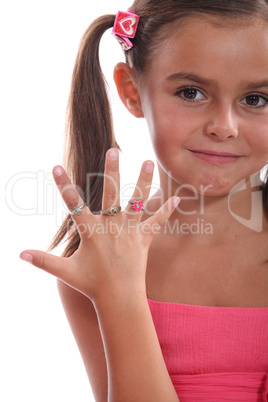 cute little girl showing the rings on her hand