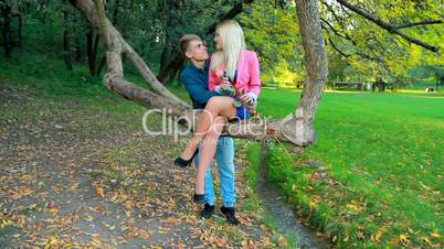 young couple on background of autumn trees.
