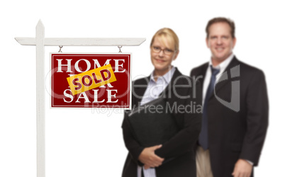 Businesswoman and Businessman Behind Real Estate Sign Isolated