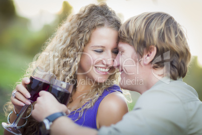 An Attractive Couple Enjoying A Glass Of Wine in the Park