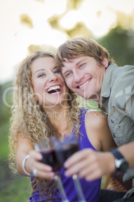 An Attractive Couple Enjoying A Glass Of Wine in the Park