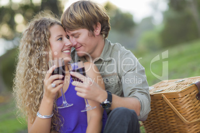 An Attractive Couple Enjoying A Glass Of Wine in the Park