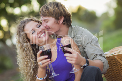 An Attractive Couple Enjoying A Glass Of Wine in the Park