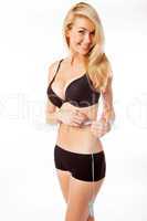 blonde woman measuring her stomache