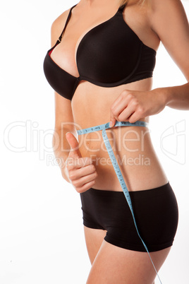 woman measuring her waist