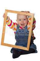 Laughing baby playing with picture frame