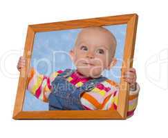 Baby holding a frame around her head