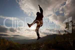 Happy man jumping at the sunset