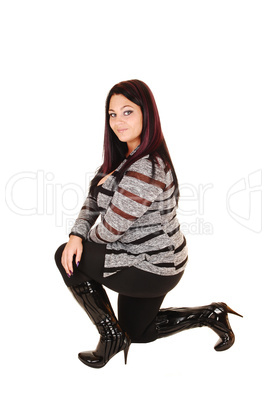 Girl in boots kneeling.