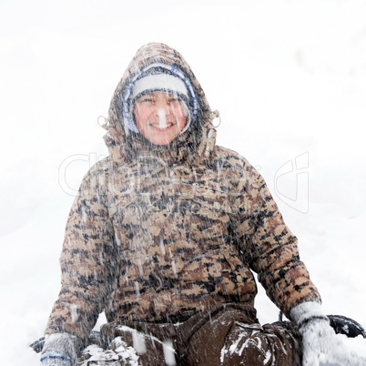 Boy winter portrait at snowfall