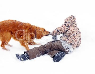 Boy playing with dog at snow