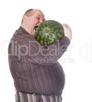 Obese man biting a watermelon