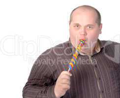 Fat man enjoying a lollipop