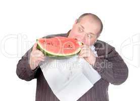 Fat man tucking into watermelon
