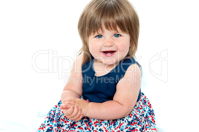 Portrait of an adorable baby girl sitting up