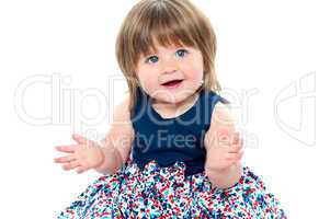 Chubby little toddler wearing dotted blue frock