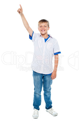 Charming casual boy pointing upwards