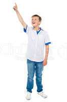 Charming young boy pointing towards copyspace area