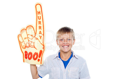 Boy with a hurray boo foam hand. Young fan