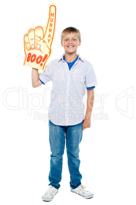 Young boy wearing a large foam hand