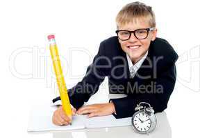 Casual shot of a school kid finishing his assignment in time