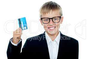 Young kid in business suit flaunting a debit card