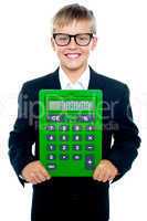 Bright young kid holding large green calculator
