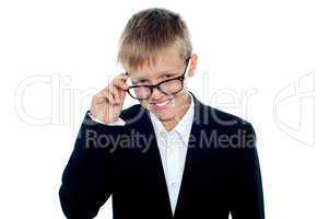 Young business boy looking through his glasses