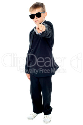 Small boy in blue suit pointing at you