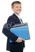 Cheerful little boy holding business files