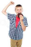 Boy cheering and enjoying choco chip cookie