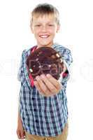 Happy little young boy holding choco chip cookie
