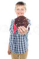 Sweet little boy offering you a chocolate cookie