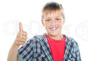 Boy in trendy clothes showing thumbs up sign