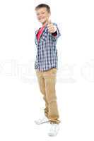 Smartly dressed young kid showing thumbs up gesture