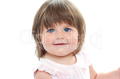 Closeup shot of a chubby female kid with blue eyes