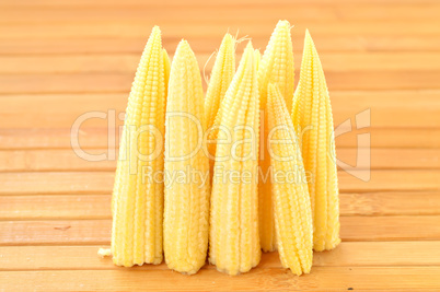 Baby corn on a background of the boards