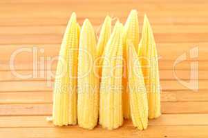 Baby corn on a background of the boards