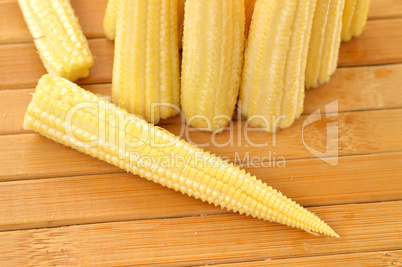 Baby corn on a background of the boards