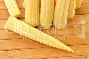 Baby corn on a background of the boards