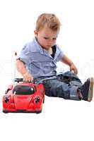 Young boy playing with a toy car