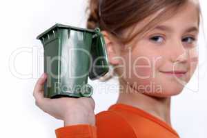 Girl holding mini green bin