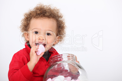 A cute kid eating marshmallow
