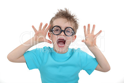 Child wearing wacky glasses and making a silly face