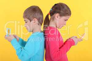 Brother and sister with hand-held video games