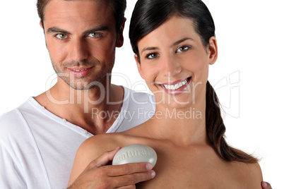 Couple in studio holding pebble