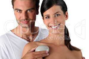 Couple in studio holding pebble